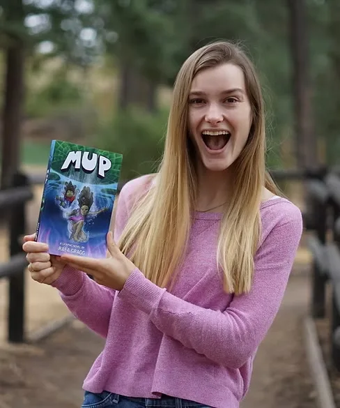 Raea holding a Mup book